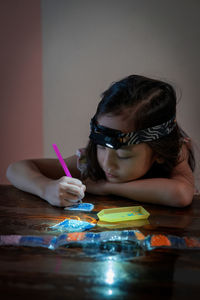 Side view of young woman painting