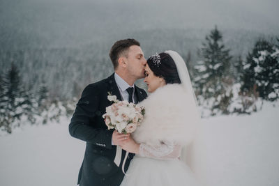 Couple holding hands on snow