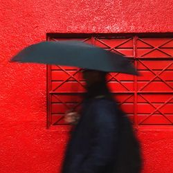 Shadow of person on red wall