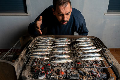 Man preparing food on barbecue grill