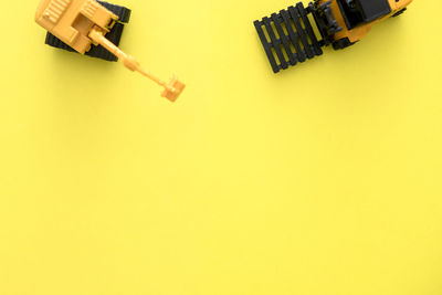 High angle view of toy car on yellow background