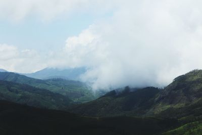 Scenic view of mountains against cloudy sky