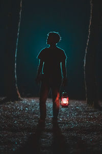 Full length of man standing on illuminated street light