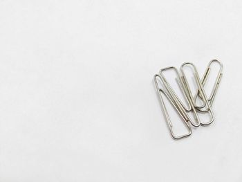 Directly above shot of paper clips on gray background