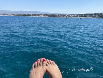 Low section of woman in sea