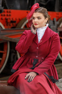 Portrait of young woman sitting on street