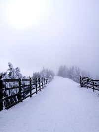 Snow covered landscape against sky