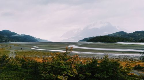 Scenic view of lake and mountains against sky
