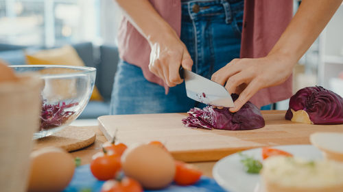 Midsection of man preparing food on table