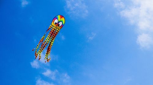 Low angle view of kite in blue sky