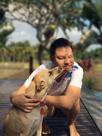 Young woman with dog sitting outdoors