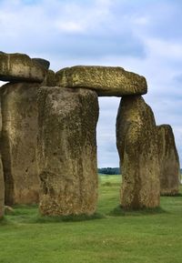 Stone structure on field against sky