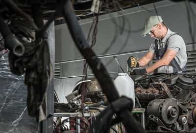 Man wearing cap working on garage