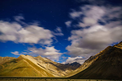 Low angle view of snowcapped mountains against sky