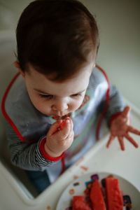 High angle view of cute girl eating fruit