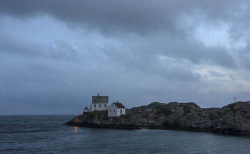 Scenic view of sea by building against sky