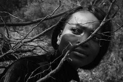 Close-up portrait of woman with tree