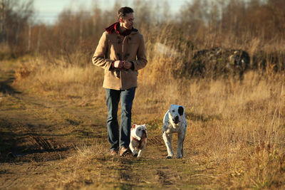 Man walking with dogs on land