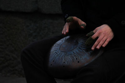 Cropped hands of person playing musical instrument