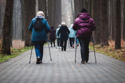 Pole walking for seniors, group of women walk for good health in the park