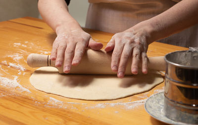 Close-up of man preparing food on table