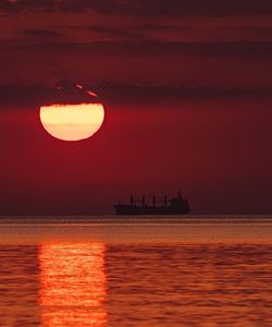 Scenic view of sea against orange sky