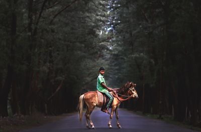 Boy riding a horse