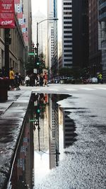 City street by buildings during rainy season