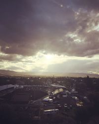 View of cityscape against cloudy sky