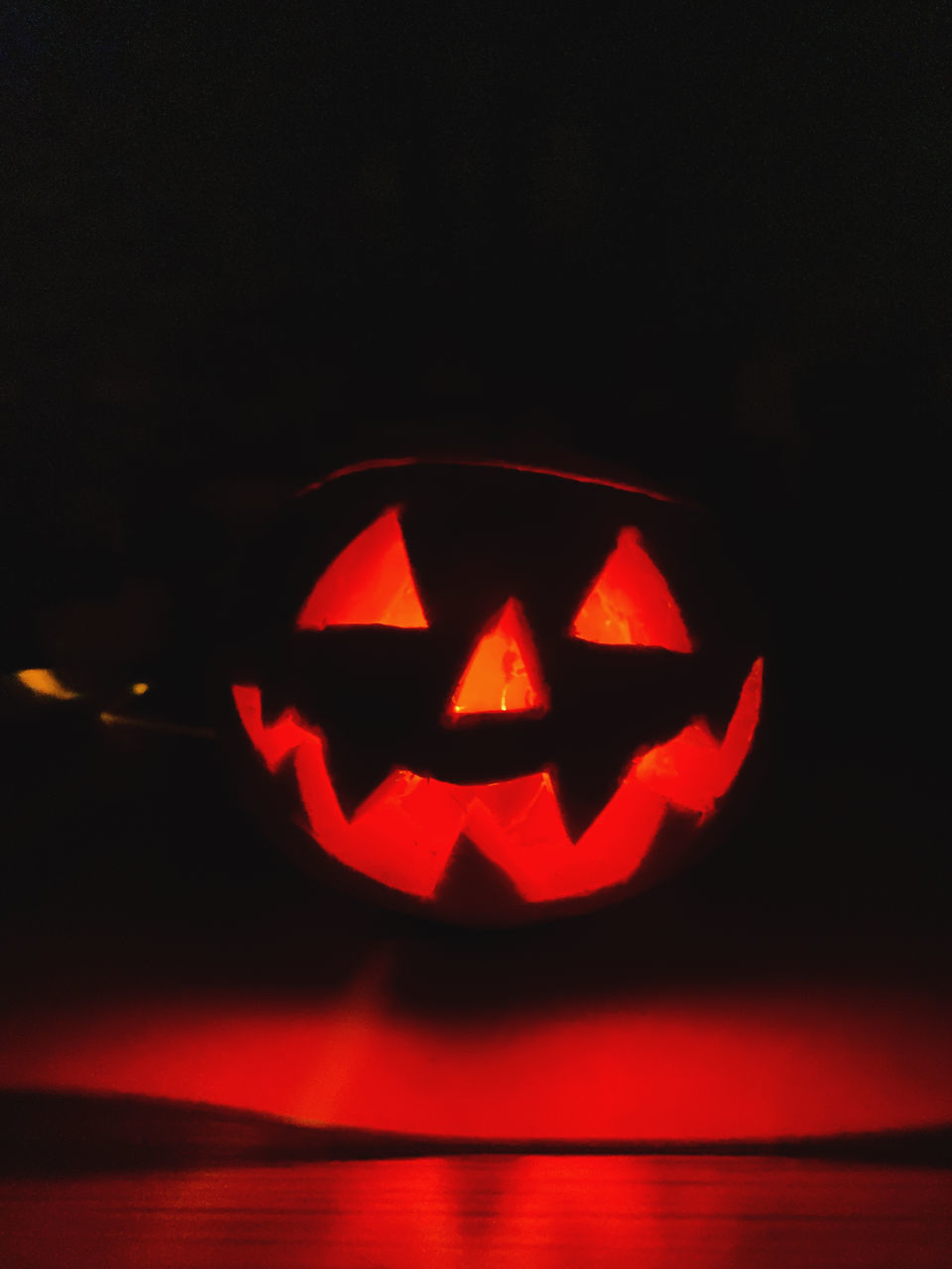CLOSE-UP OF ILLUMINATED HALLOWEEN PUMPKIN
