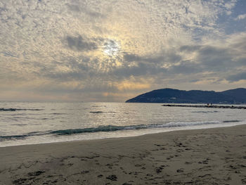 Scenic view of beach against sky during sunset