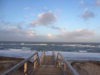 Pier over sea against sky