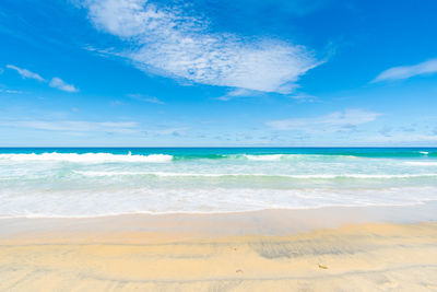 Scenic view of beach against blue sky