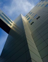 Low angle view of skyscraper against cloudy sky