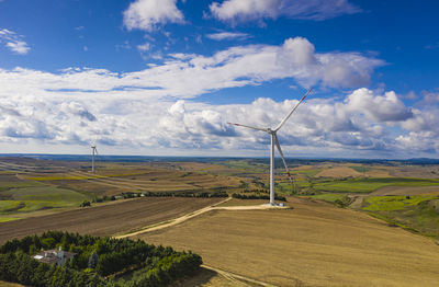 Windmill on field against sky