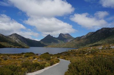 Scenic view of lake by mountains against sky