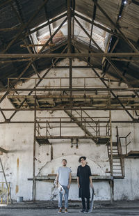 Full length of men standing in abandoned building