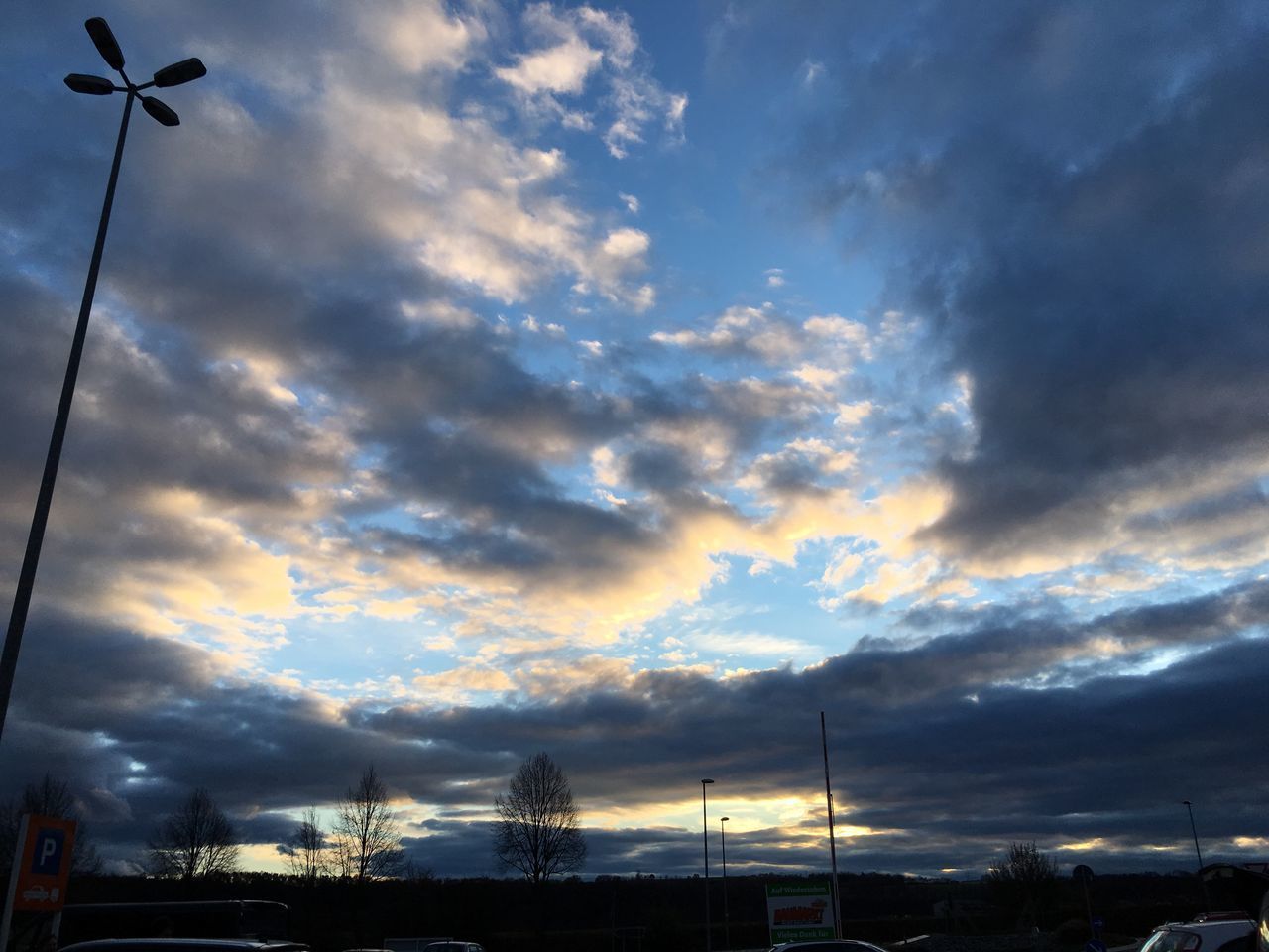 LOW ANGLE VIEW OF SILHOUETTE STREET LIGHTS AGAINST SKY DURING SUNSET