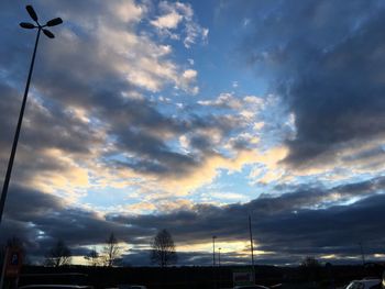 Low angle view of silhouette street against sky during sunset