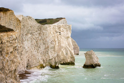 Scenic view of rocks in sea against sky