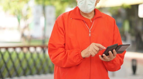 Low angle view of man holding mobile phone