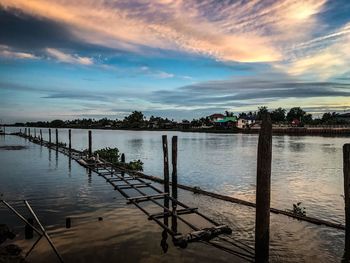 Scenic view of river against sky at sunset