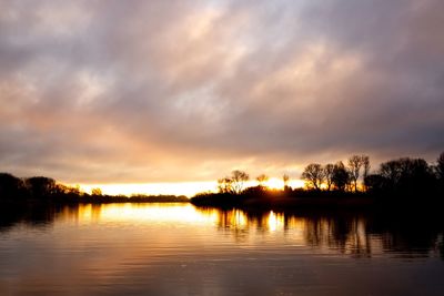 Scenic view of lake against sky during sunset