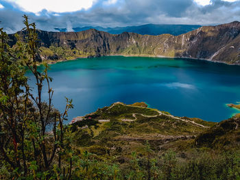Scenic view of lake against cloudy sky