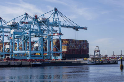 Commercial dock by sea against sky