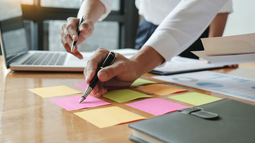 Midsection of woman working on table