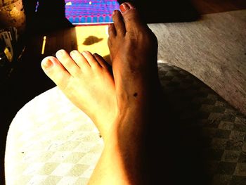 Low section of woman feet on table