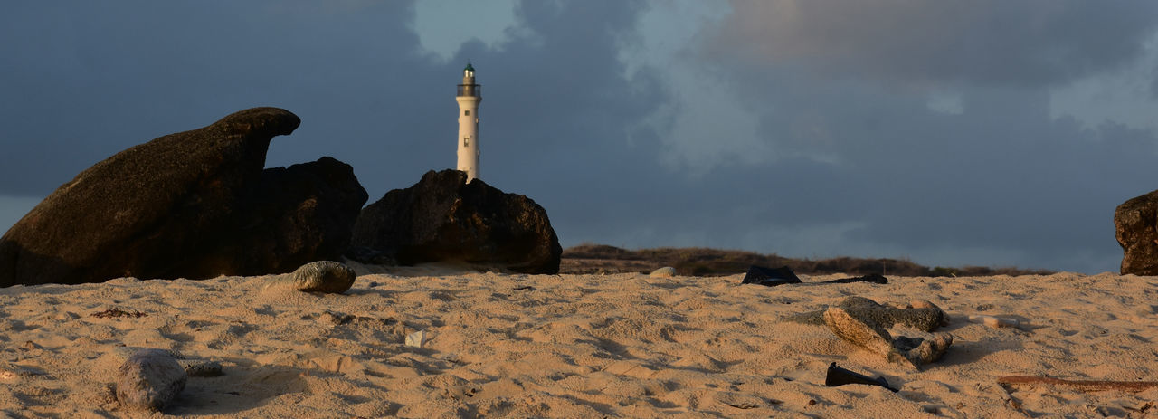 rock, sky, nature, cloud, land, natural environment, landscape, lighthouse, travel destinations, sand, environment, scenics - nature, panoramic, no people, architecture, sea, tower, travel, outdoors, beauty in nature, rock formation, mountain, animal, animal themes, terrain, animal wildlife