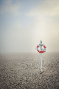 Lifeguard hut on beach against sky