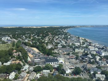 High angle view of townscape by sea against sky
